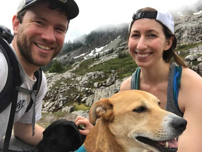 Sniffspot founder, David Adams and Rebecca Sheppard with their dogs outdoors, hiking