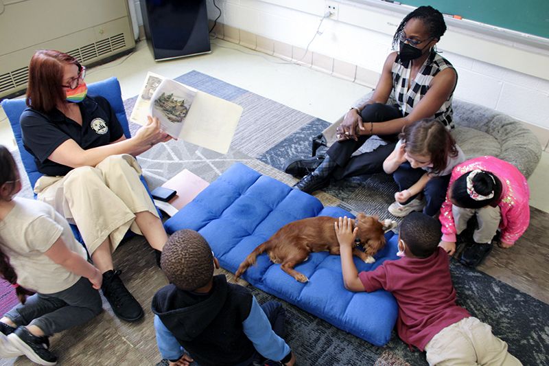 Classroom with children reading with a dog in Michigan’s River Rouge school district.