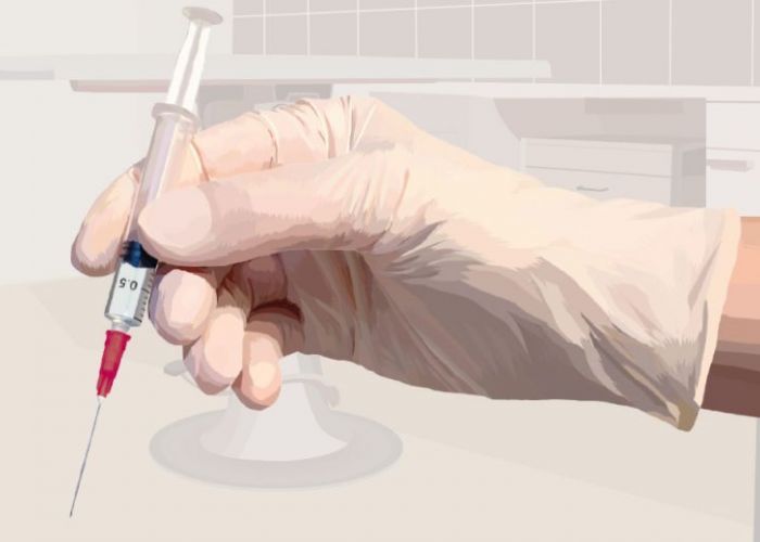 Illustration of a gloved hand holding a syringe