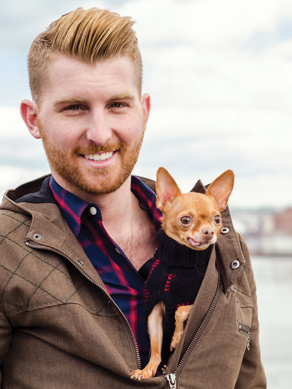 a man holds a small dog tucked into his jacket