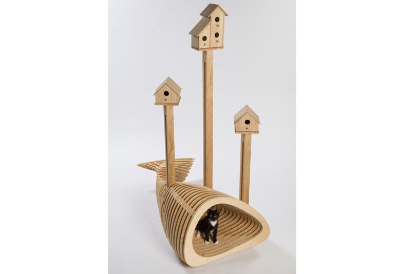 a multi tiered wooden structure whose bottom is shaped like a fish tail and topped by bird houses