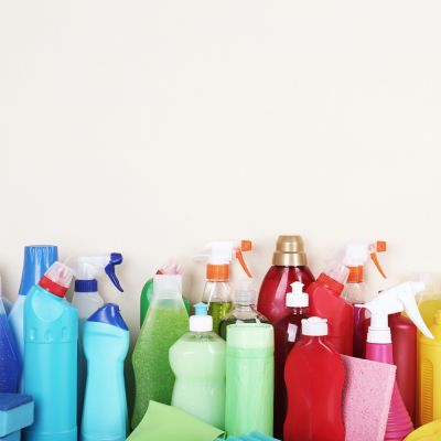 an assortment of cleaning products arranged by color