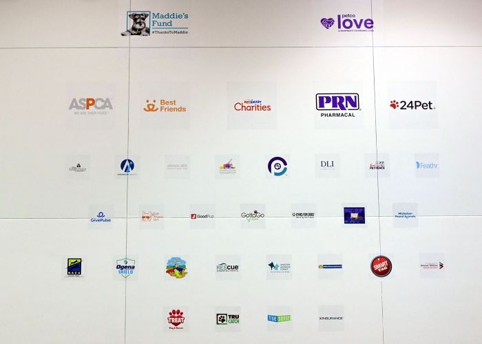 a collection of sponsor logos on a white wall