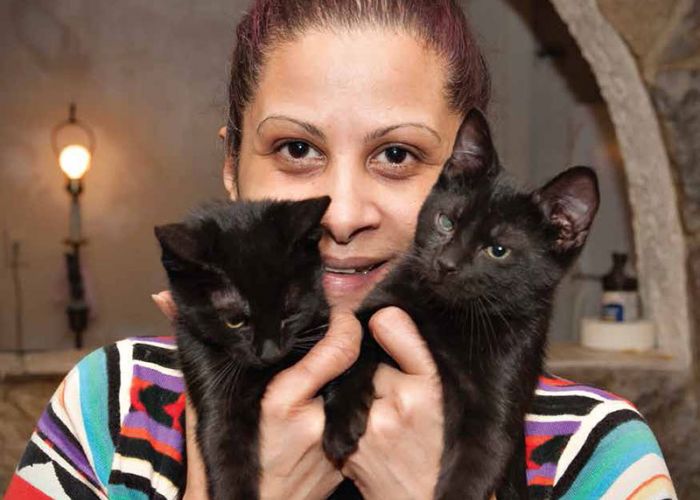Woman with two black cats